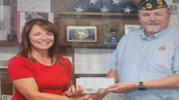 Lesa Robke presenting check to Clarence Fry.